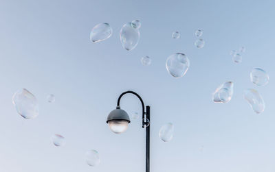 Low angle view of bubbles against white background