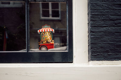 Close-up of christmas decoration behind window