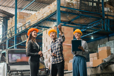 Portrait of young woman standing in factory