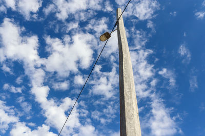 Low angle view of light pole against sky