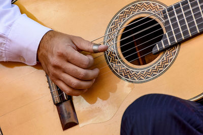 Close-up of man playing guitar outdoors
