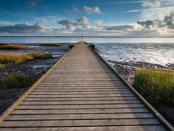 Pier over sea against sky