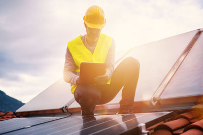 Rear view of young woman using mobile phone