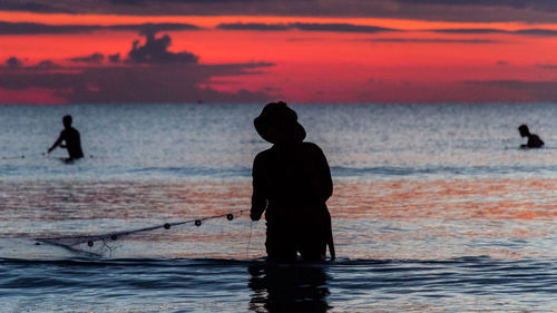 A fisherman is fishing at sunset on koh rong, cambodia