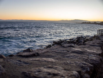 Scenic view of sea against clear sky during sunset