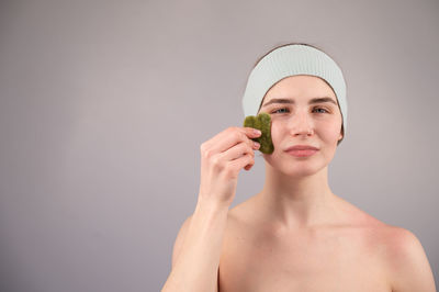 Woman holding gua sha stone