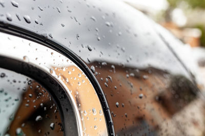 Close up of wet black car part.