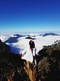 Man standing on mountain against sky