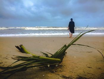 Man standing on beach against sky