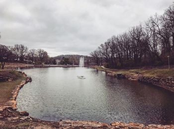 Scenic view of river against cloudy sky