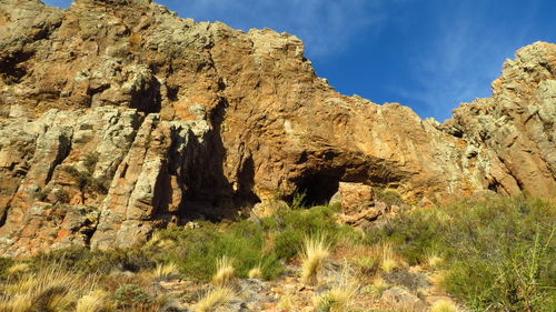 Low angle view of rock formations against sky