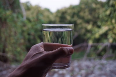 Close-up of hand holding drinking glass