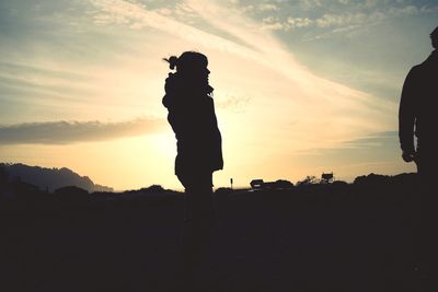 Silhouette of man and woman at sunset