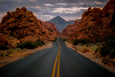 Road amidst mountains against sky