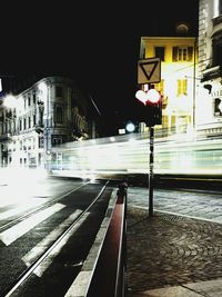 Railroad tracks in city at night