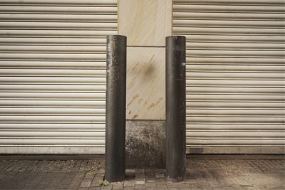 Bollards against closed shutters on street