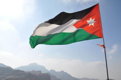 Low angle view of flag against sky