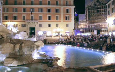 Group of people in illuminated building at night