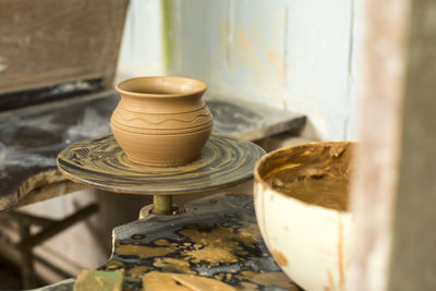 Close-up of clay pot on spinning wheel at carpentry