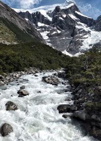 Scenic view of river flowing through mountains