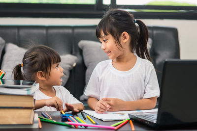 Siblings sitting on table