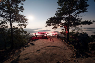 Light painting on rocky above misty landscape. fullmoon night adventure in wild nature