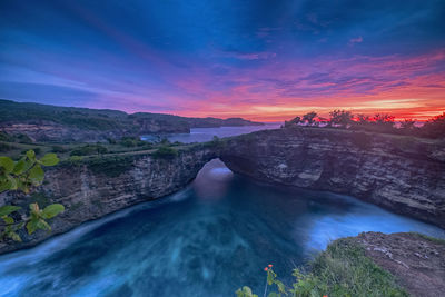 Scenic view of river against sky during sunset