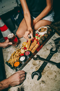 High angle view of people preparing food on table