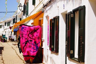 Clothes drying against buildings in city