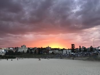 Scenic view of beach against dramatic sky