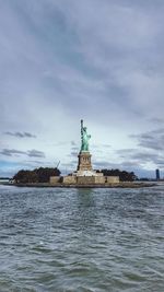 Statue of sea with city in background