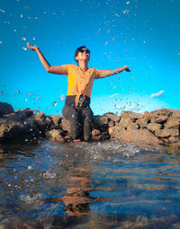 Cheerful woman playing with water