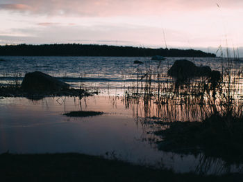 Scenic view of lake against sky during sunset