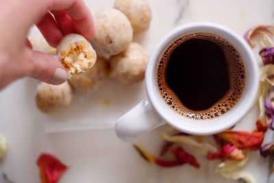 Cropped hand holding coffee cup