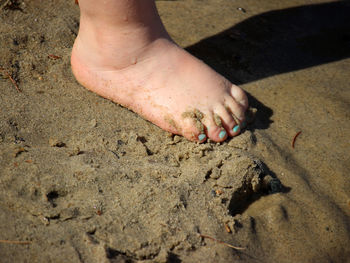 Low section of man on sand