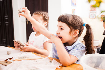 High angle view of siblings and woman on table