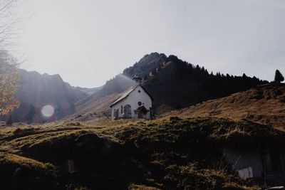 Panoramic view of houses and mountains against sky