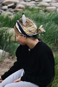 Midsection of woman sitting on field