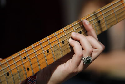 Close-up of hand playing guitar