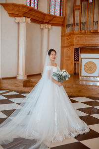 Low section of bride standing in traditional clothing