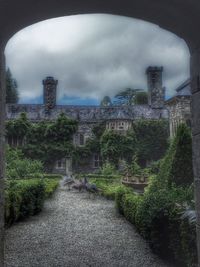 View of footpath against cloudy sky