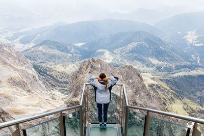 Rear view of man standing on mountain