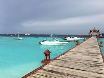 Boats moored at harbor