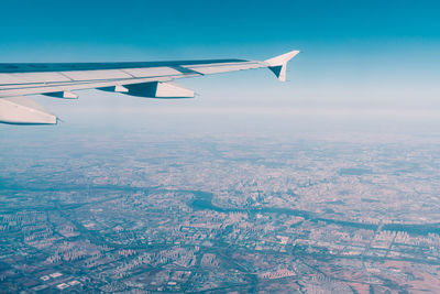 Aerial view of airplane flying in sky