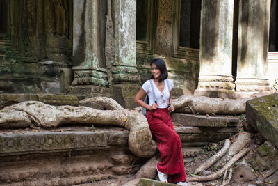 Thai girl is exploring the ancient ruins of angkor wat hindu temple complex in siem reap, cambodia