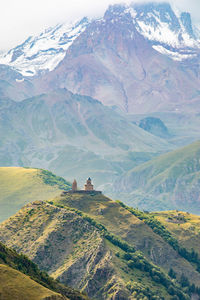Scenic close up view of kazbek mountain and gergeti trinity church in georgia at sunrise in summer
