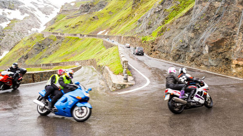 People riding motorcycle on road