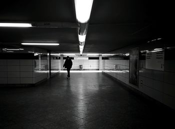 Rear view of woman walking in subway