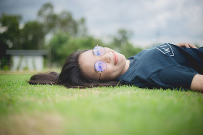 Portrait of man lying on grass
