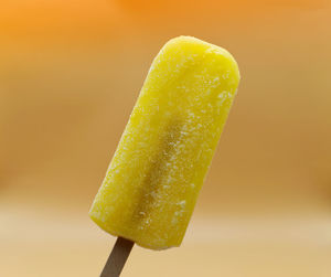 Close-up of ice cream against orange background